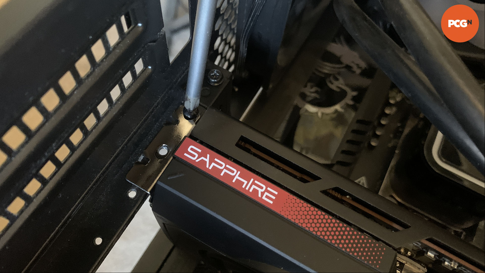 How to install a graphics card: Unscrew Sapphire AMD Radeon RX 7600.