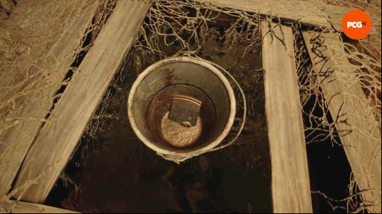 A piece of a puzzle sits in a bucket in a well in Alone in the Dark.