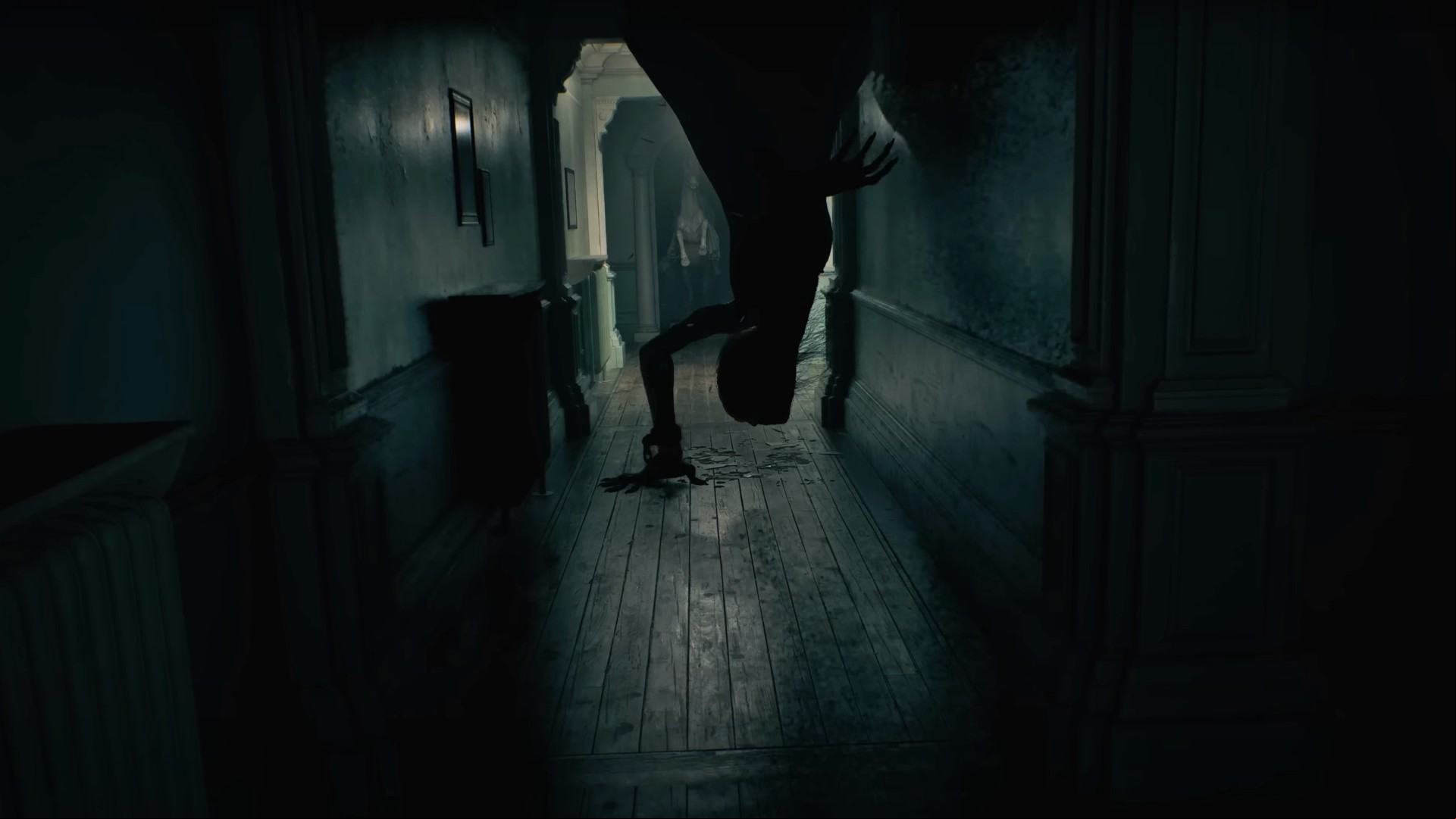RE9 release date: A mutant crawls down from the ceiling to the floor in what appears to be the Wrenwood Hotel's corridor, a statue of a horse rearing standing in the doorway behind it.