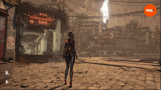 Stellar Blade PC review: A woman with black hair wearing a black jumpsuit, seen from behind, standing in a courtyard with neon signs, Eve from Stellar Blade.